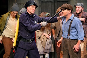 Officer Lockstock (Bradley Greenwald) and Bobby Strong (Patrick Morgan) with URINETOWN company. Photo by Michal Daniel.