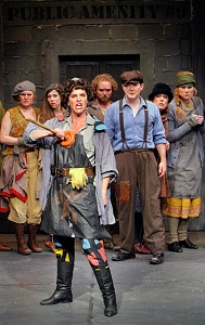 Penelope Pennywise (Kersten Rodau) with members of the URINETOWN company. Photo by Michal Daniel.